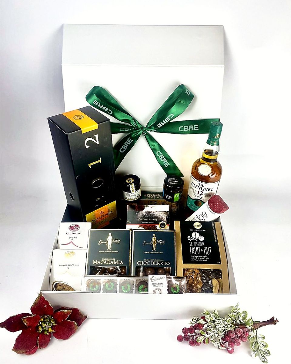 Christmas hamper with Champagne and whisky, finished with a branded green ribbon